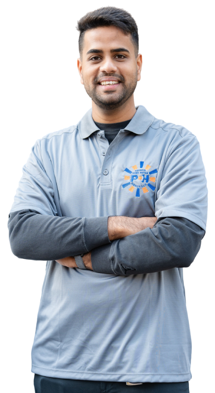 A man in a grey company shirt standing with his arms crossed against a plain background.