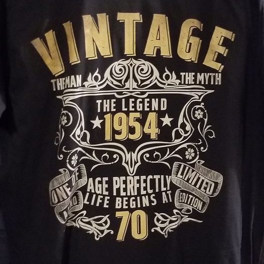 A black t-shirt design with the text "VINTAGE The Legend 1954 Age Perfectly Life Begins At 70."